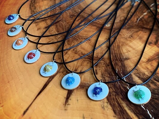 ball of yarn with knitting needles necklace
