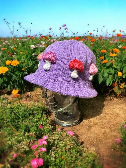 Knitted bucket hat with toadstool mushrooms around the brim