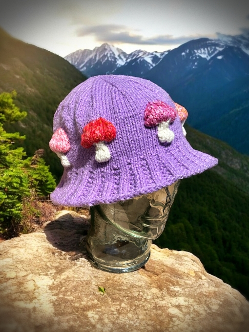 Knitted bucket hat with toadstool mushrooms around the brim