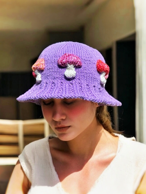 Knitted bucket hat with toadstool mushrooms around the brim