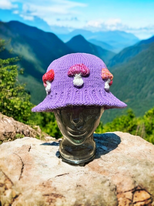 Knitted bucket hat with toadstool mushrooms around the brim