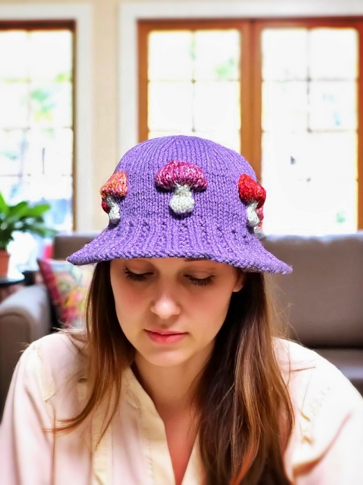 Knitted bucket hat with toadstool mushrooms around the brim