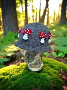 Knitted bucket hat with toadstool mushrooms around the brim