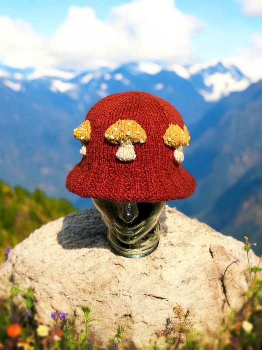 Knitted bucket hat with toadstool mushrooms around the brim