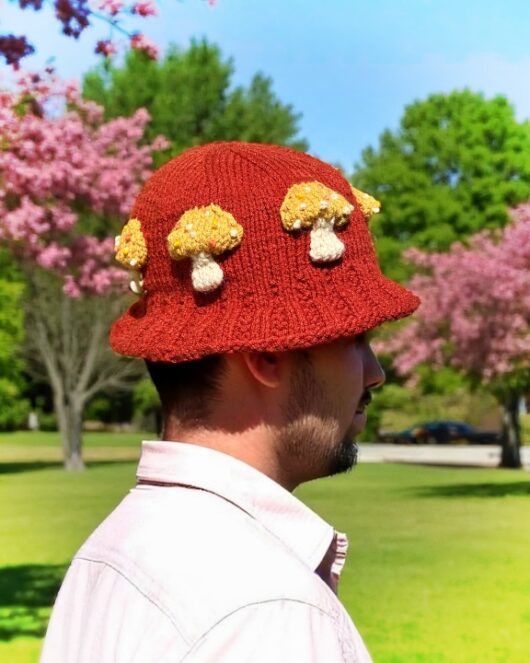 Knitted bucket hat with toadstool mushrooms around the brim