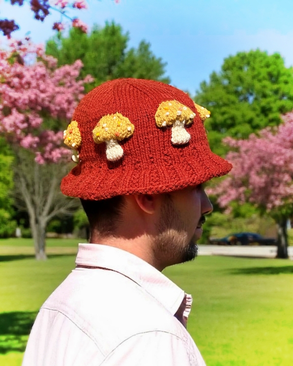 Knitted bucket hat with toadstool mushrooms around the brim