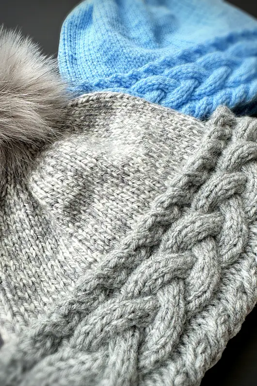 Cable knit bobble beanie free knitting pattern laid flat showing textured stitches