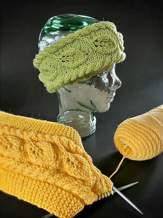 Hand knit winter Headband or ear warmer with a repeating leaf motif - free knitting pattern.