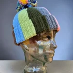 Free scrap yarn bobble beanie knitting pattern shown on glass mannequin head