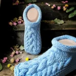 Cable knit slipper knitting pattern featuring extra cozy handmade slippers with a textured cable design