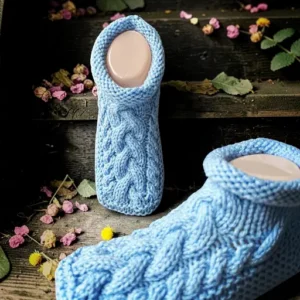 Cable knit slipper knitting pattern featuring extra cozy handmade slippers with a textured cable design