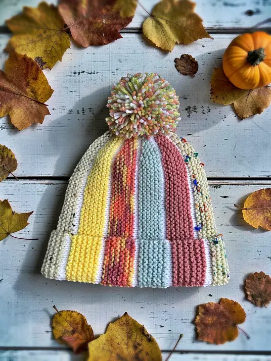 Free knitting pattern for Scrap Beanie tall bobble hat version laid flat with bobble texture and striped colour accents