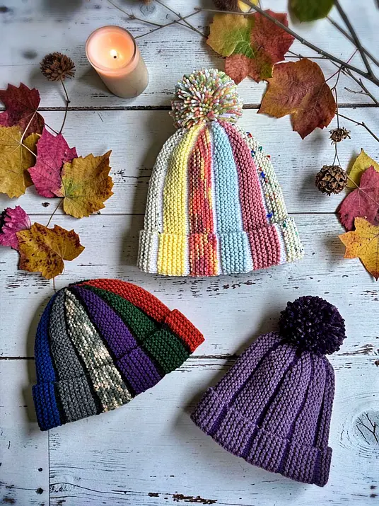 Scrap yarn knitting pattern for bobble beanie and fisherman hat styles displayed flat on a light background