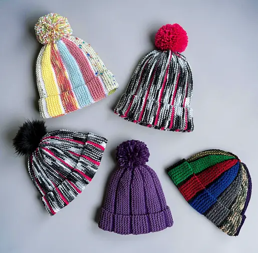 Free knit hat pattern showing Scrap Beanie with textured bobble sections and contrasting colour stripes