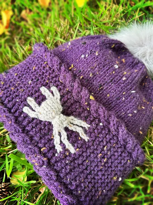 Close-up of spider colourwork on a Halloween beanie knitting pattern
